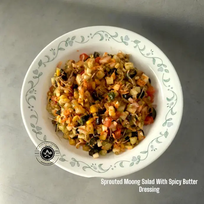 Bowl of sprouted moong salad with vegetables and spicy butter dressing