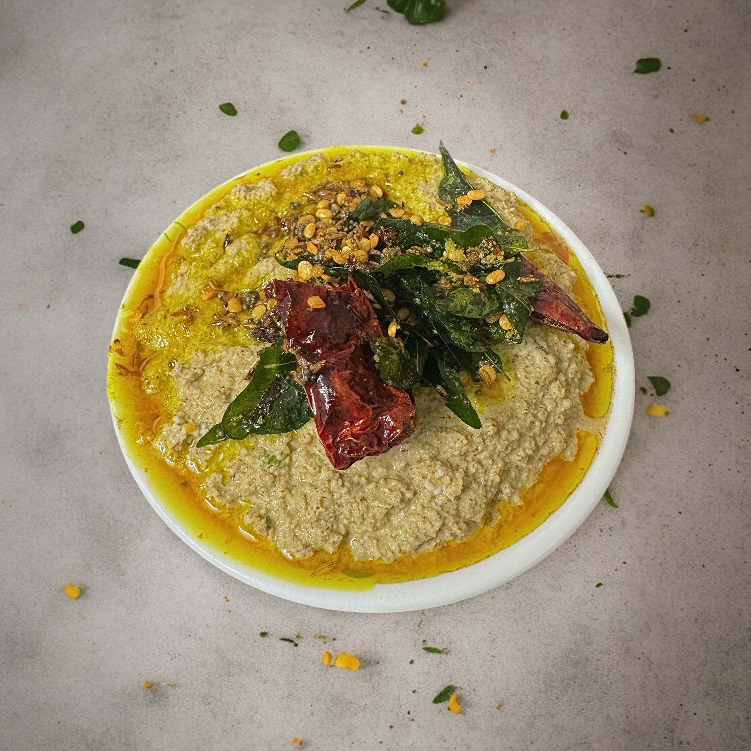 Traditional chutney with tender tamarind leaves, garlic, chillies, and grated coconut