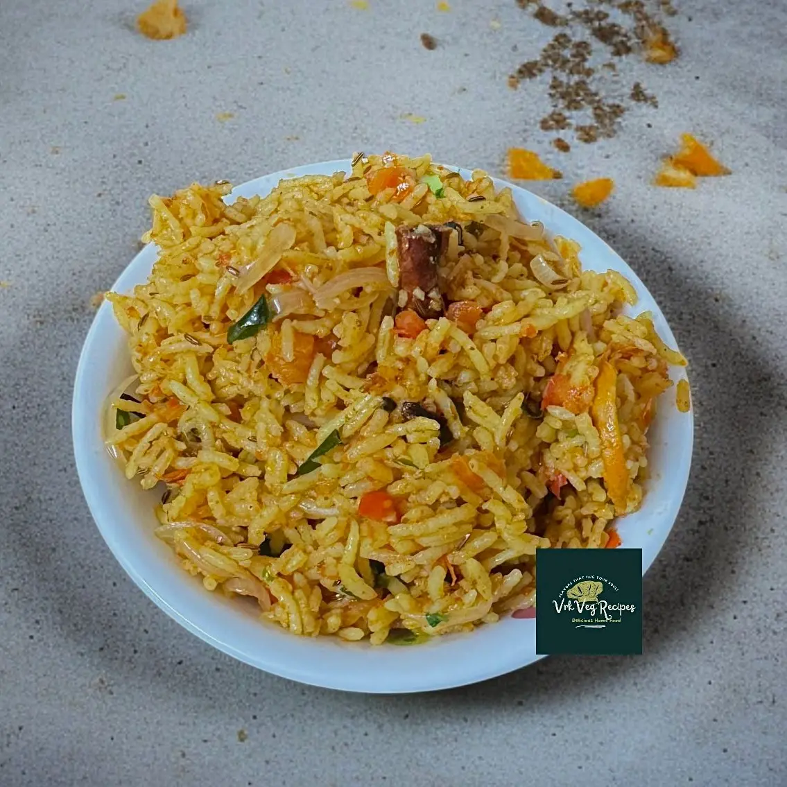 Fragrant tomato rice cooked with whole spices, onions, and ghee, served hot and garnished with fresh coriander leaves.