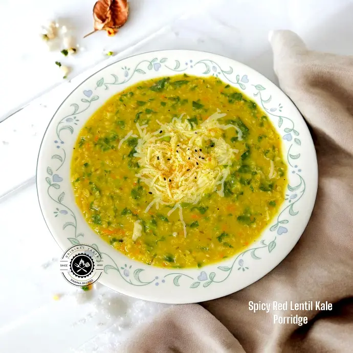 Wholesome red lentil and kale mix cooked with veggies, oats, and aromatic spices for a filling and healthy breakfast or dinner.