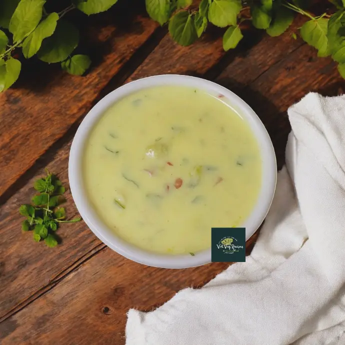 Cooling and wholesome South Indian-style curd-based snake gourd curry with spices, onion, and ginger-chilli paste.