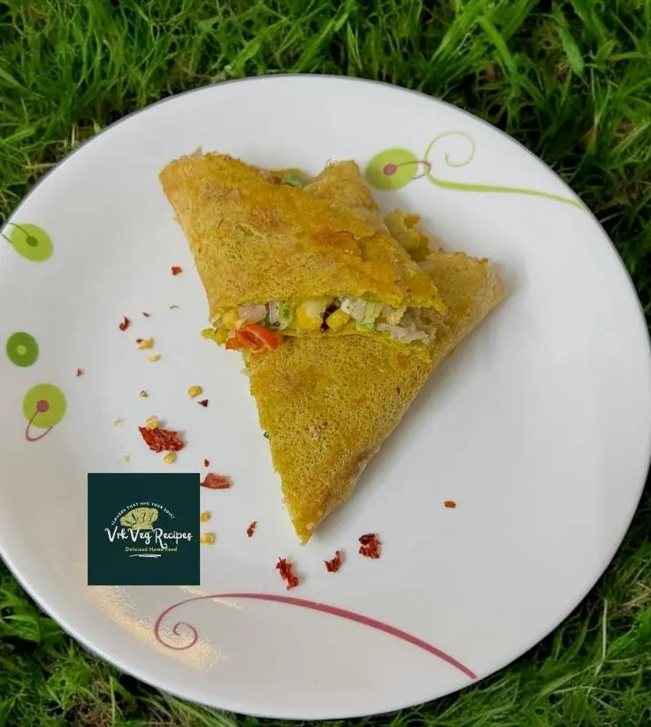 Healthy red lentil dosa wraps filled with zucchini, corn, and creamy paneer spread, served warm and fresh.