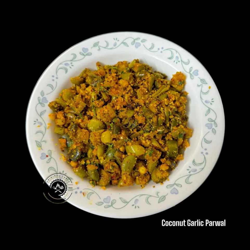 Parwal with Roasted Coconut & Garlic Parwal and coconut dry curry cooked with red chillies, roasted chana dal, cumin, and a crunchy garlic tempering.