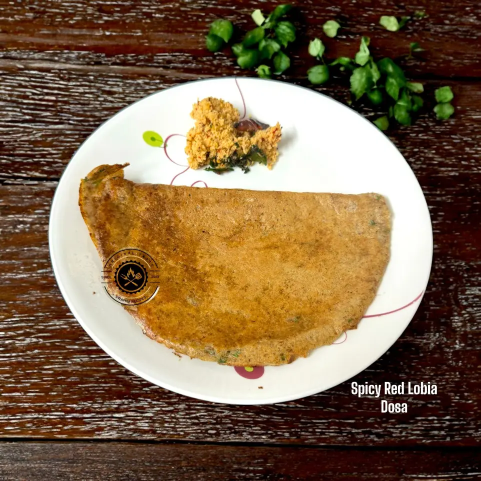 Protein-Rich Red Lobia Dosa for Breakfast Spicy red cowpea dosa loaded with pepper, green chillies, and herbs, sizzling hot on a dosa pan.