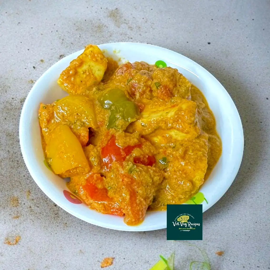 Paneer and capsicum simmered in creamy curry with coconut, peanuts, and Indian spices, perfect for lunch or dinner.