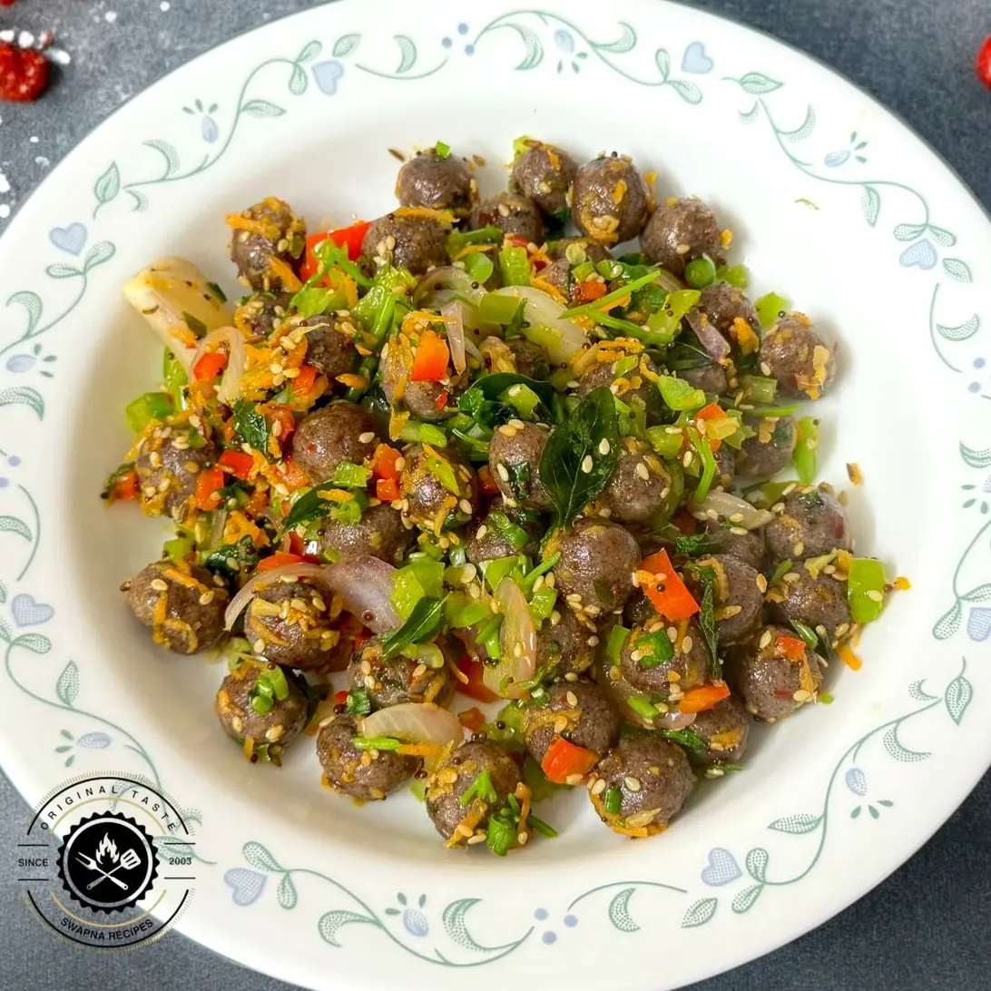 Steamed ragi and paneer balls stir-fried with colorful vegetables and South Indian spices for a healthy lunch or dinner.