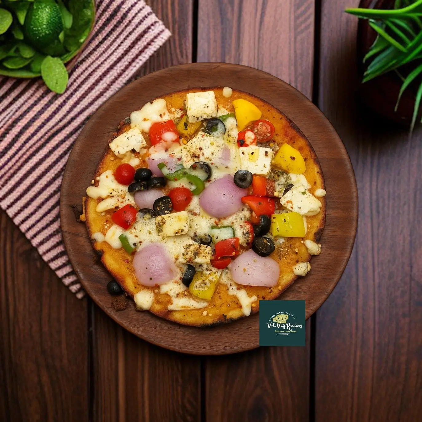 Desi-style pizza with moong dal base topped with cheese, capsicum, onion, paneer, olives, and Italian herbs.