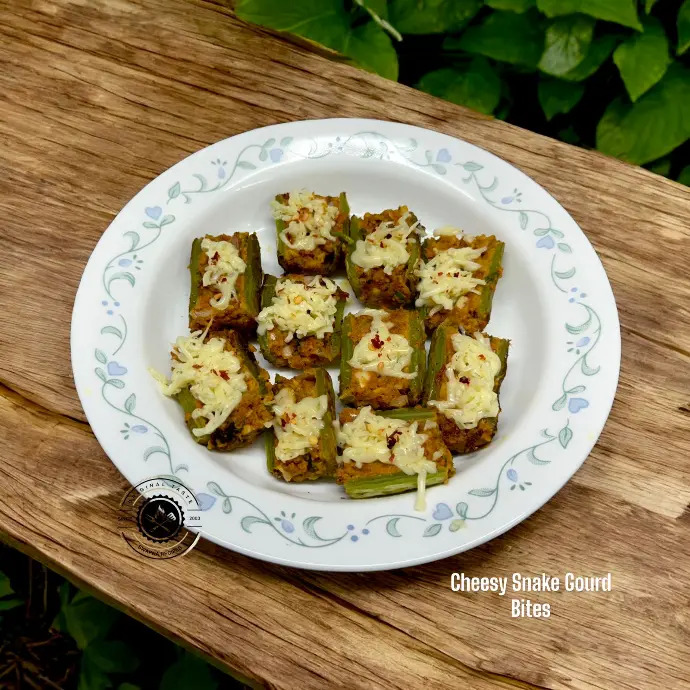 Crispy and creamy snake gourd boats cooked with spiced filling and cheese, ideal for party starters or evening treats.