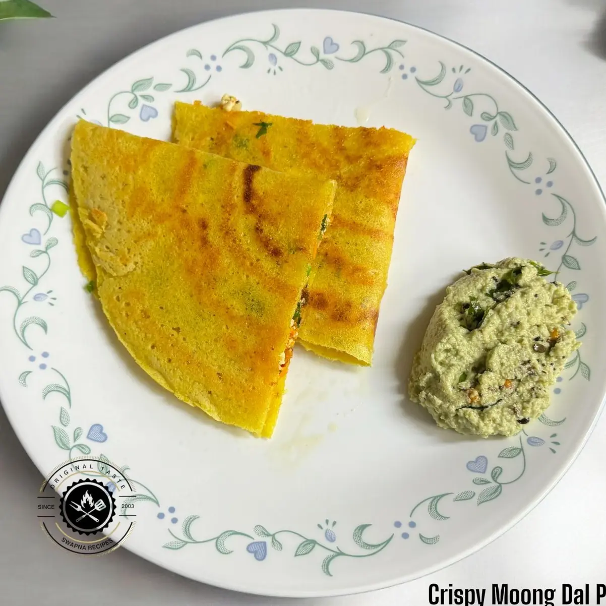 Crispy Moong Dal Paneer Dosa Recipe Crispy moong dal dosa stuffed with spicy paneer, carrots, and herbs, served golden-brown with tangy chutneys.