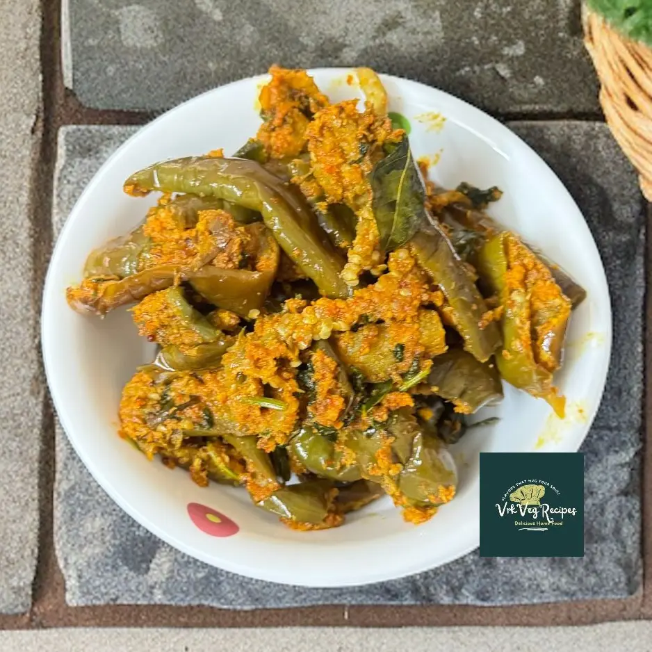 Spicy brinjal stir-fry made with dry coconut, garlic, and roasted chana dal powder, served with rice or chapati for a flavorful meal.