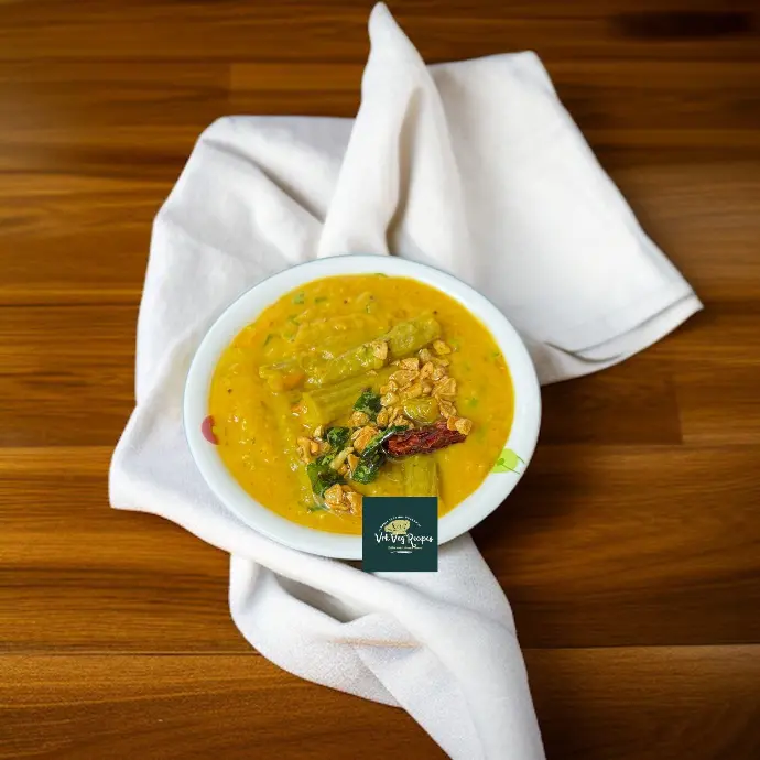 Drumstick Dal Recipe with Garlic Tempering A vibrant bowl of dal with golden garlic tempering, soft drumsticks, and rich Indian spices, served with rice or chapati.
