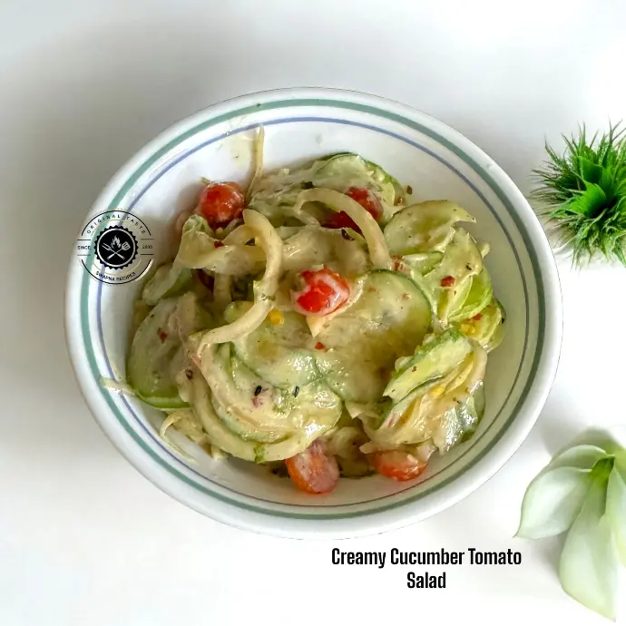 Cucumber Tomato Salad with Spiced Curd Mix Refreshing hung curd-based cucumber tomato salad mixed with garlic, lemon juice, and herbs for a flavorful, cooling dish.